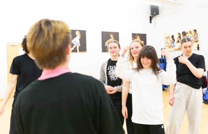 Dancers gather for notes after performing choreography.