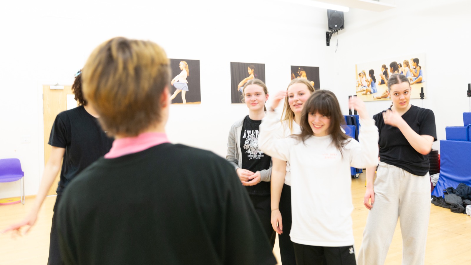 Dancers gather for notes after performing choreography.